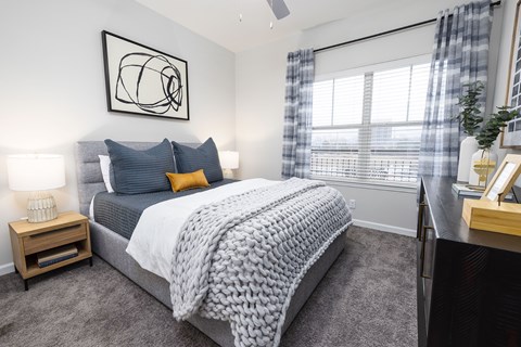 A bedroom with a large bed and a ceiling fan.