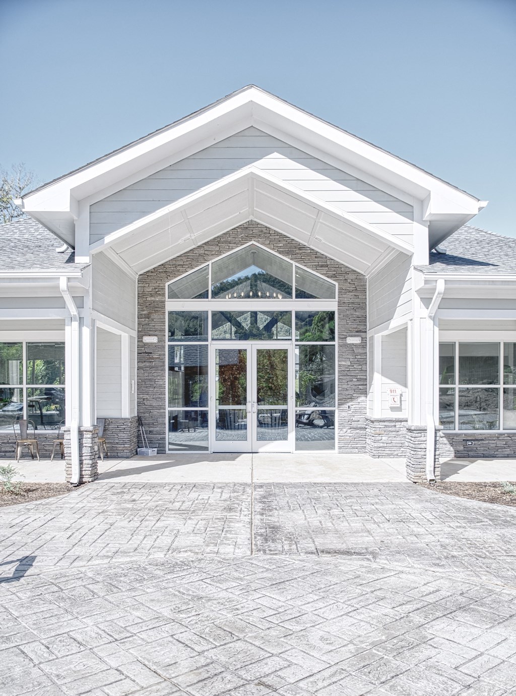 A white building with a glass door and windows.