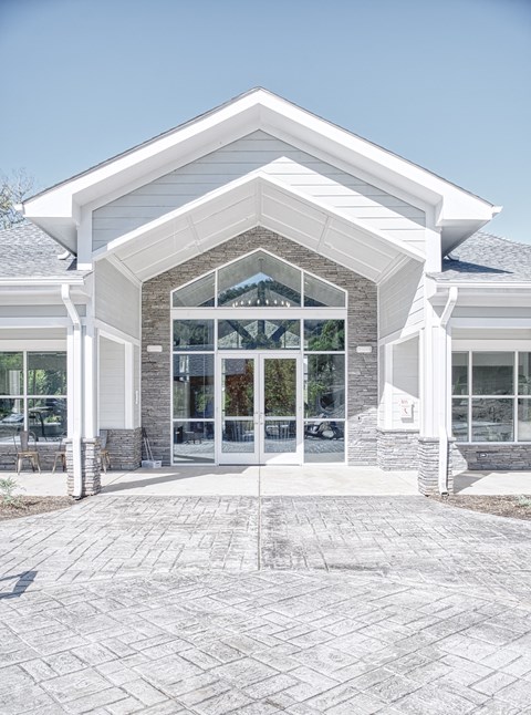 A white building with a glass door and windows.