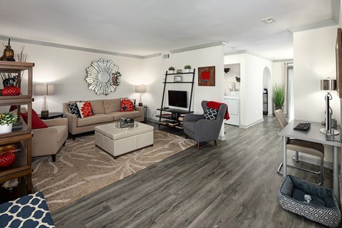 A living room with a grey couch and a white coffee table.