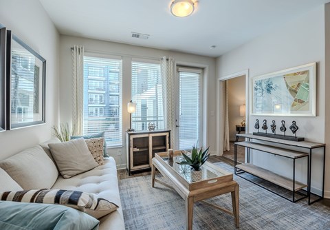 A living room with a white couch and a coffee table.
