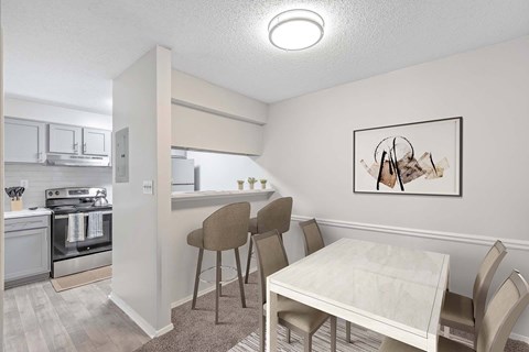 A dining area with a table and chairs.