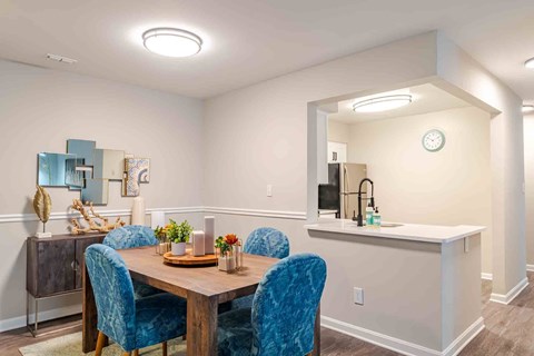 A dining room with a wooden table and blue chairs.