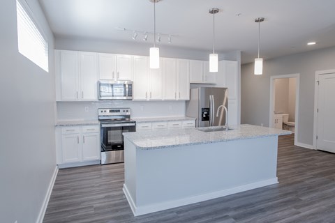a kitchen with white cabinets and a white counter top