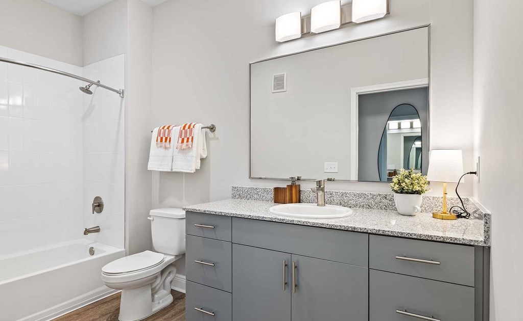 A bathroom with a white toilet and a white sink.