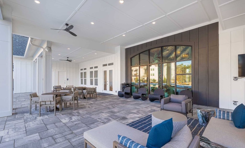 A spacious outdoor living area with a dining table and chairs.