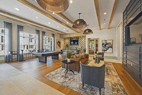a living room with a ping pong table and a couch