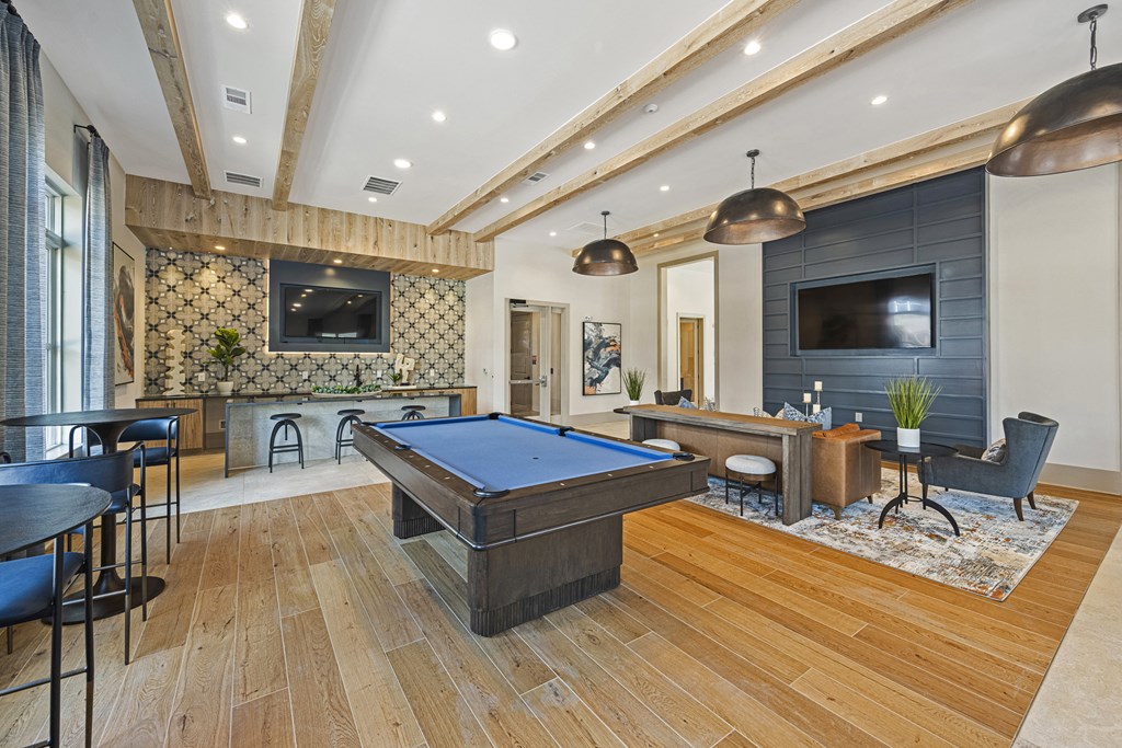 a game room with a pool table and a tv