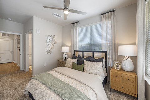 a bedroom with a bed and a ceiling fan