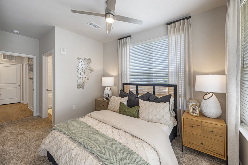 a bedroom with a bed and a ceiling fan