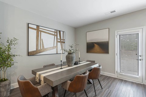 a dining room with a long table and chairs