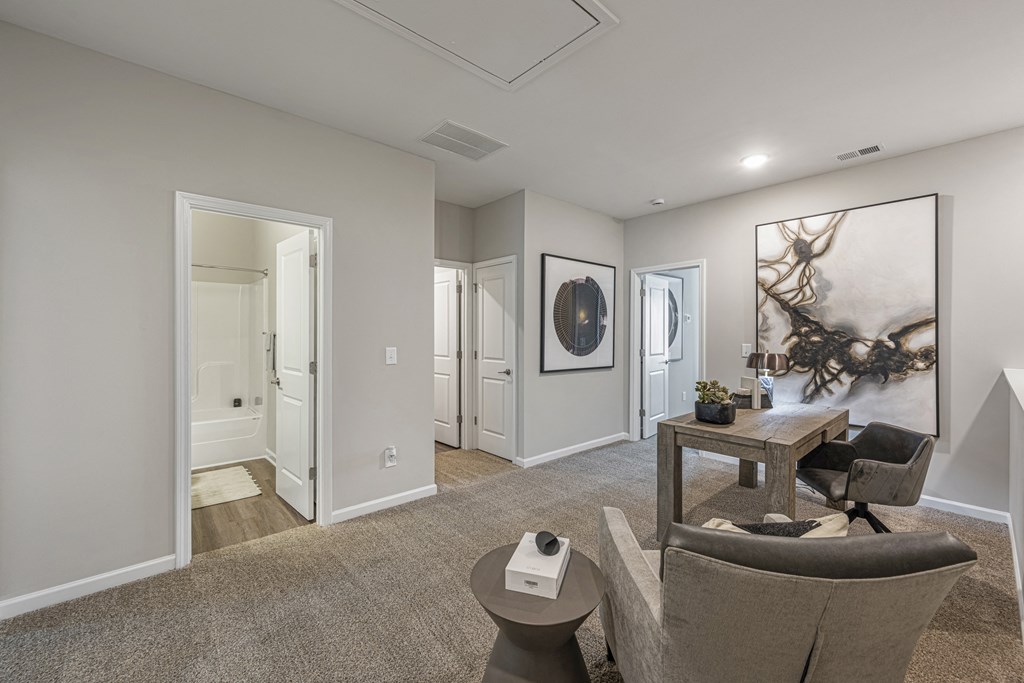 a living room with a couch and chair and a table