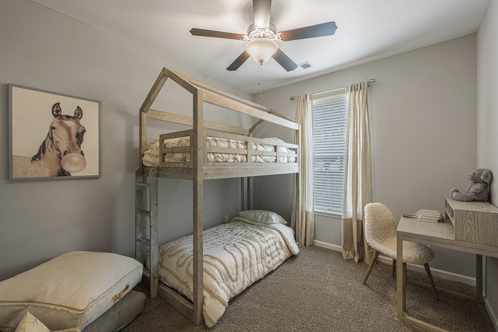 a bedroom with bunk beds and a ceiling fan