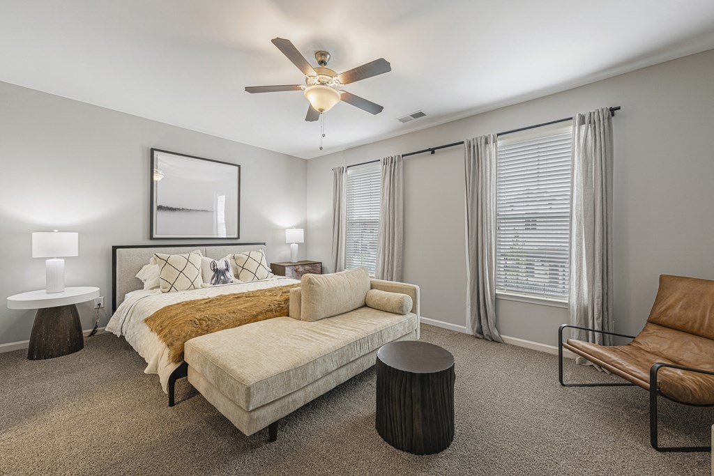 a bedroom with a bed and a ceiling fan