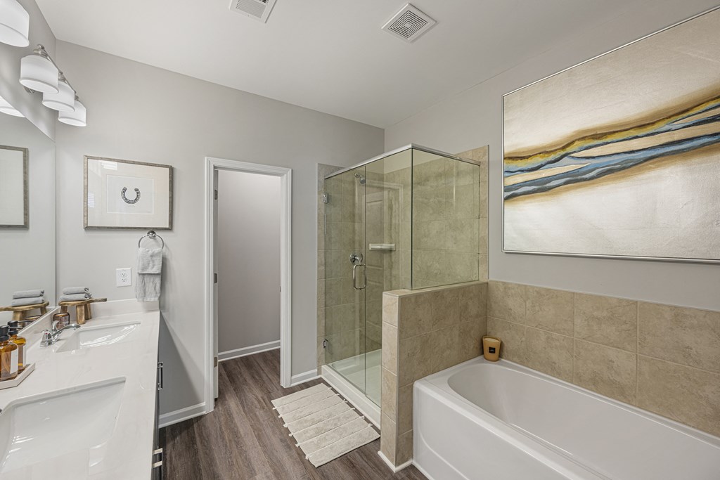 a bathroom with a tub and a shower and a sink