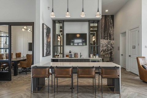 a kitchen with a counter top and chairs