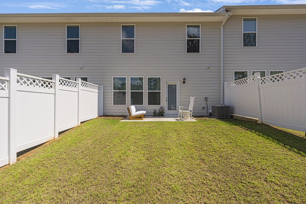 a white house with a yard and a fence