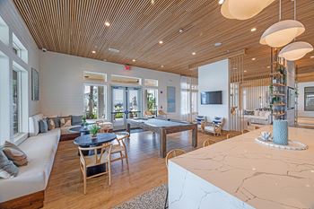a resident clubhouse with a pool table and couches