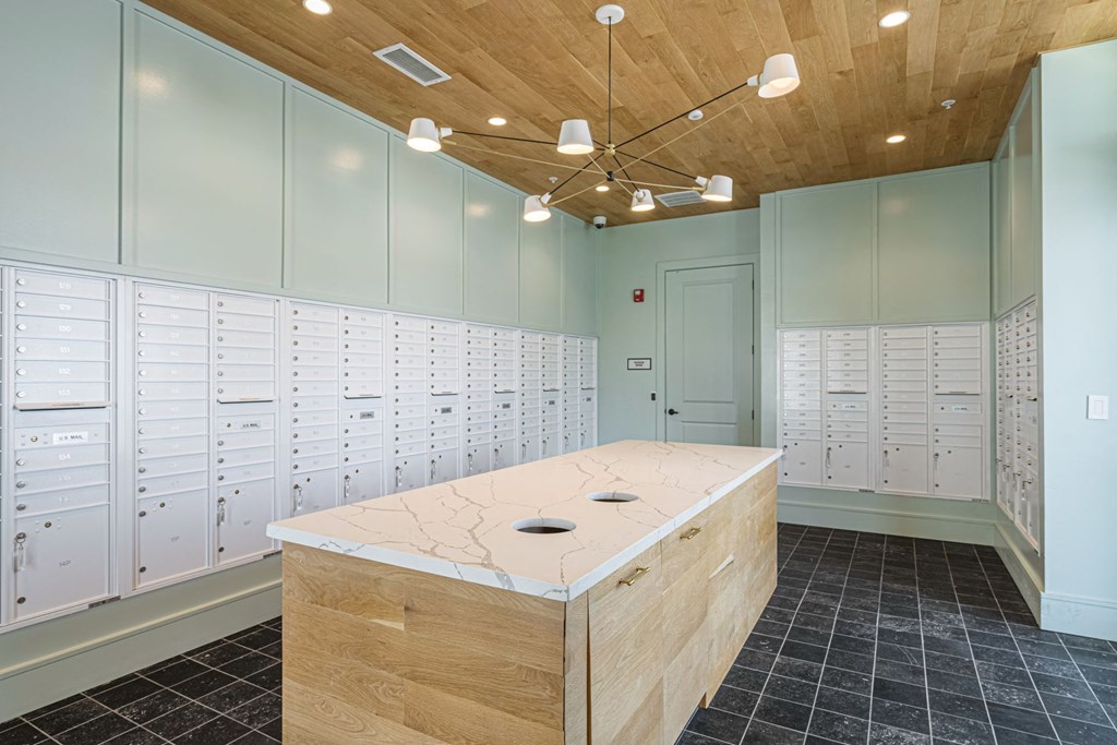 A room with a wooden ceiling and a desk with drawers.