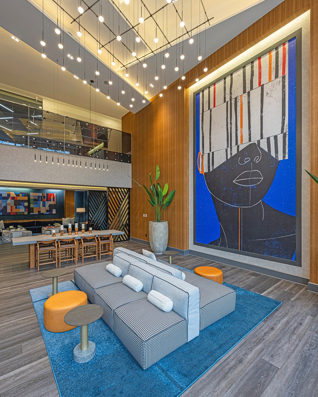 a lobby with a blue rug and a couch and a large painting
