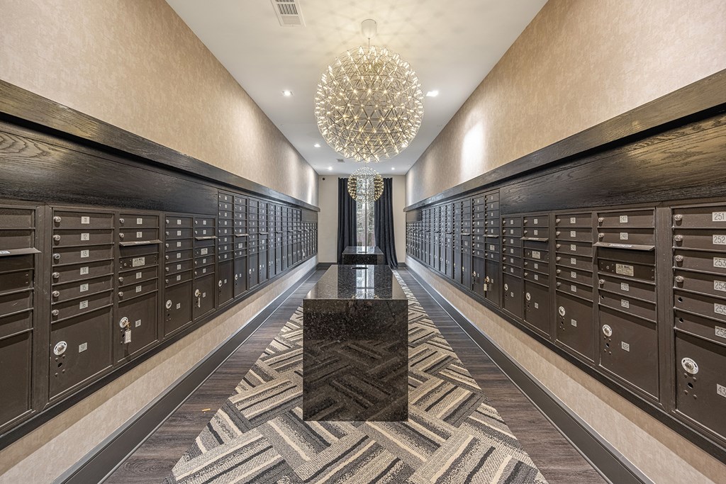 a long hallway filled with wine lockers and a large chandelier