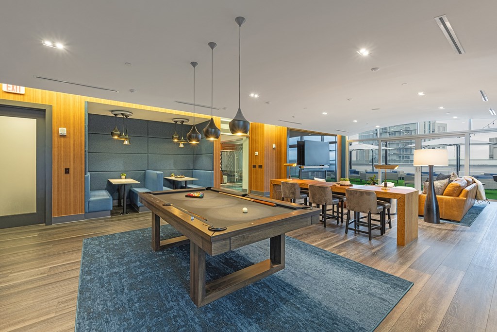 a communal area with a pool table and a dining area