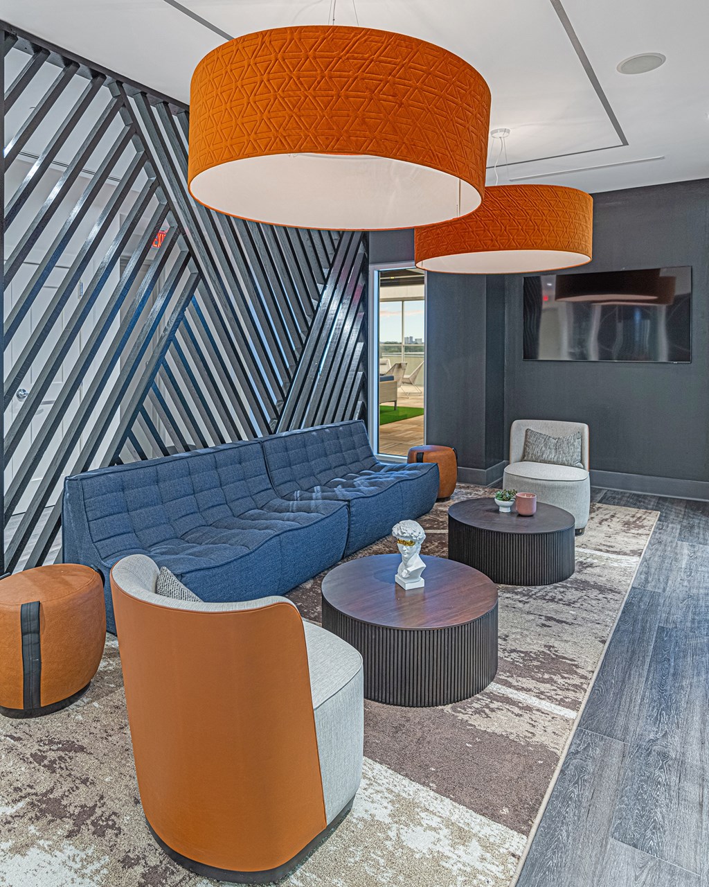 a living room with a blue couch and chairs and tables