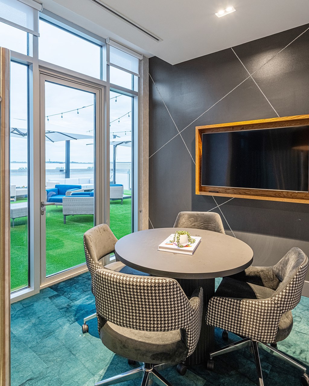 a meeting room with a table and chairs and a television