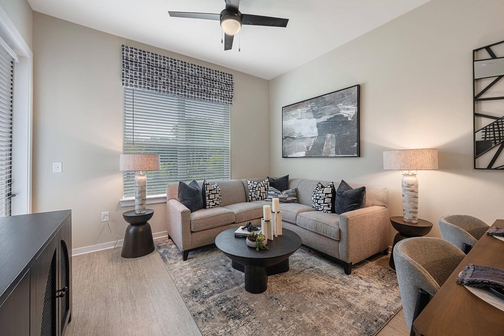 a living room with a couch and a ceiling fan