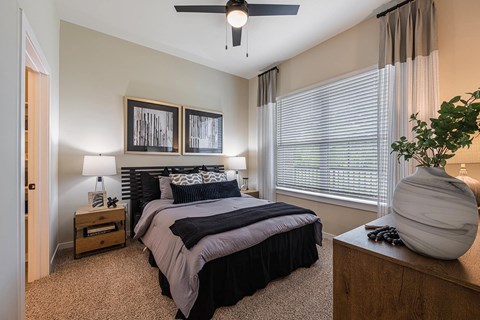 a bedroom with a bed and a ceiling fan