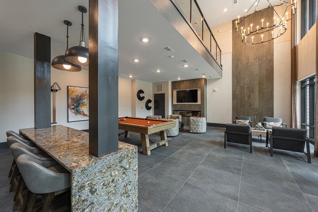 a clubhouse with a pool table and a tv