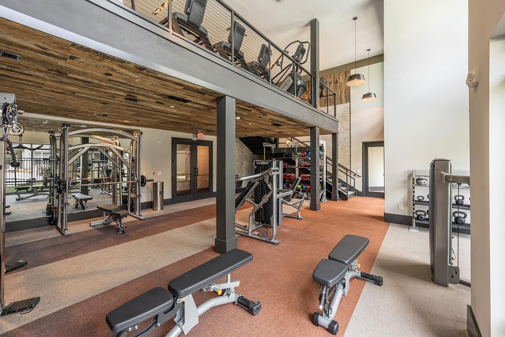 a view of the lobby of a gym with cardio machines