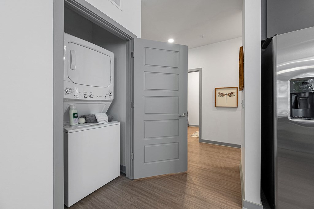 a small laundry room with a washer and dryer and a door to a