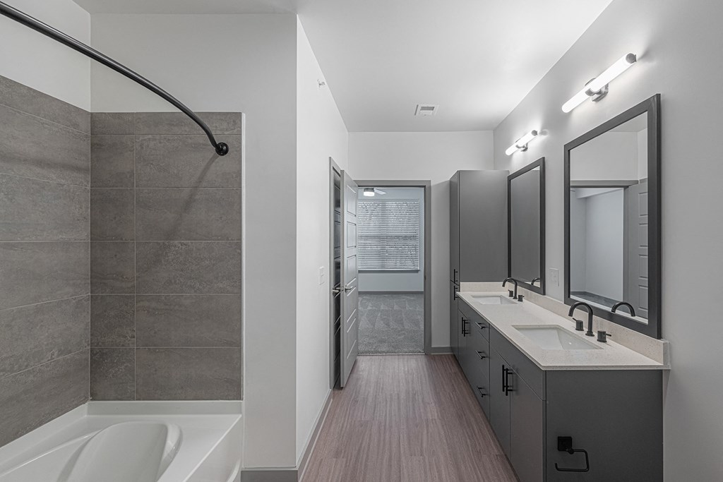 a bathroom with a shower and a sink and a mirror