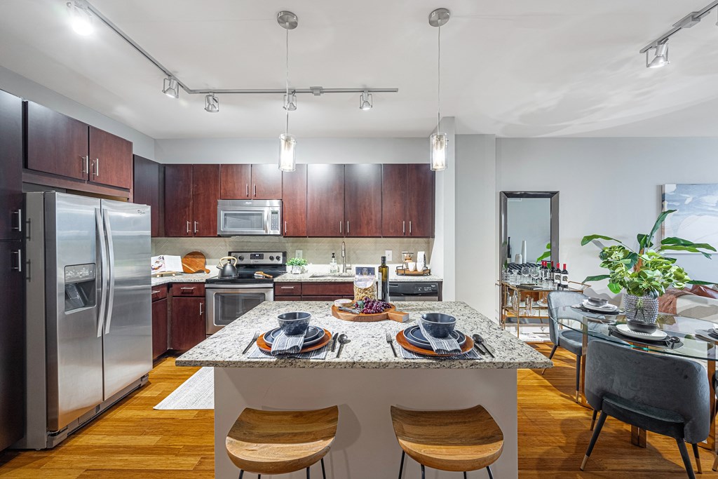 a kitchen with stainless steel appliances and a marble counter top