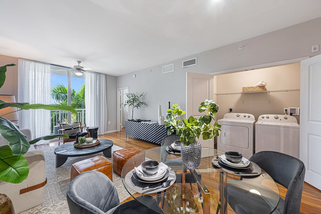 a kitchen and living room with a table and chairs