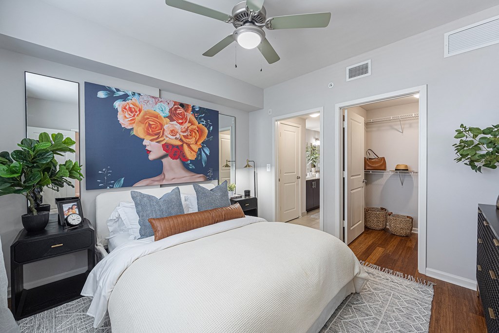 a bedroom with a large bed and a ceiling fan