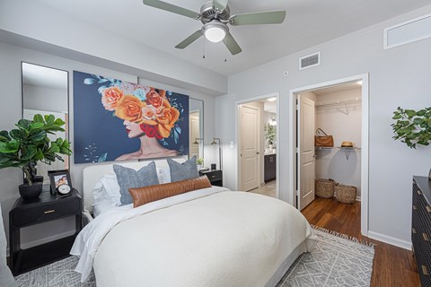 a bedroom with a large bed and a ceiling fan