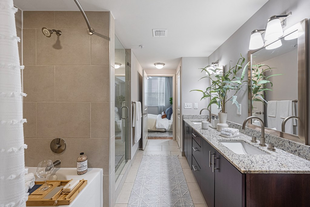 a bathroom with a shower and a sink and a mirror