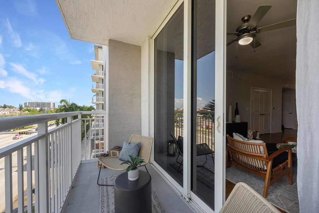 the view from the balcony of a condo with a patio and chairs