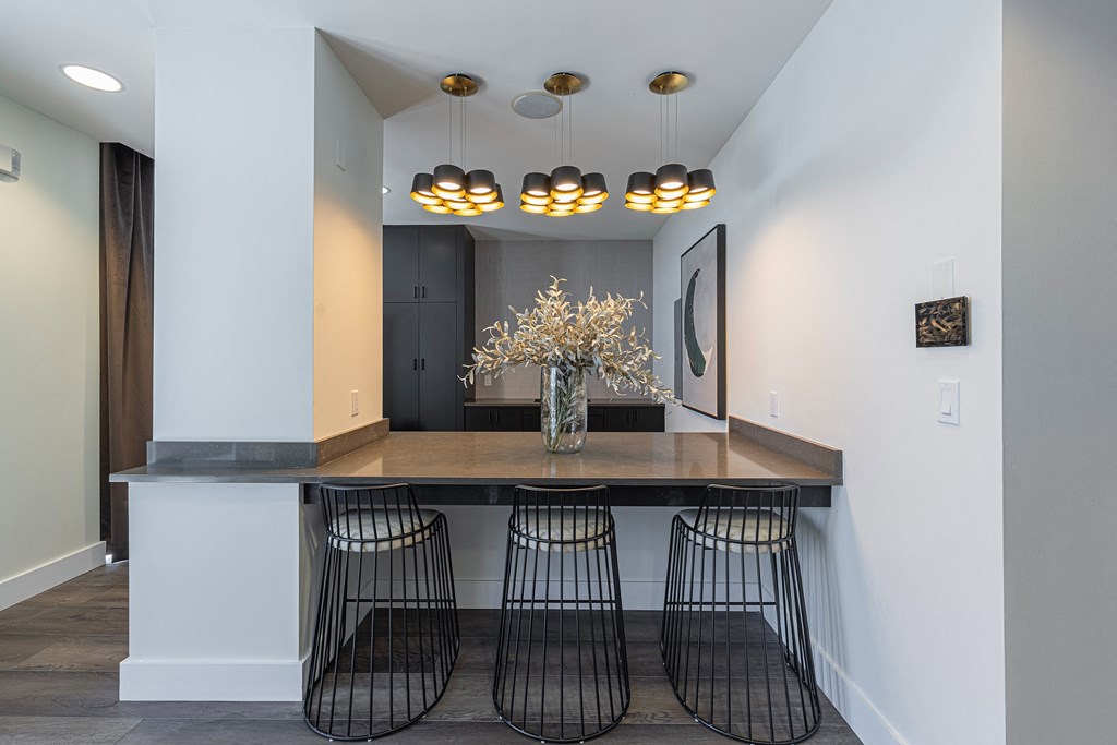 a dining room with a table and three chairs