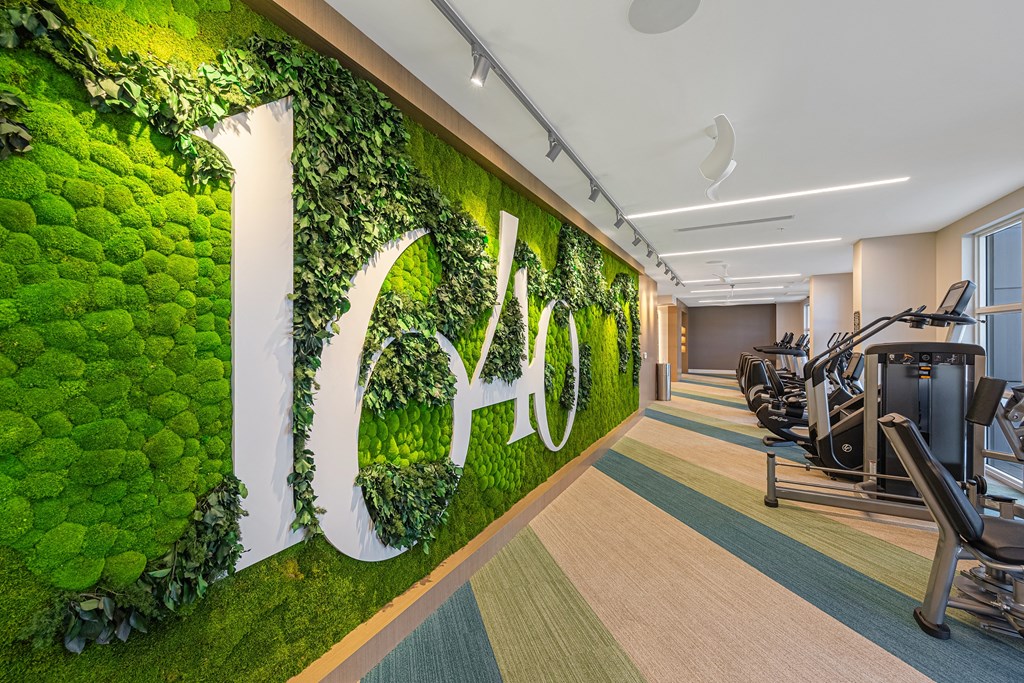 a green wall with moss and a letter on it