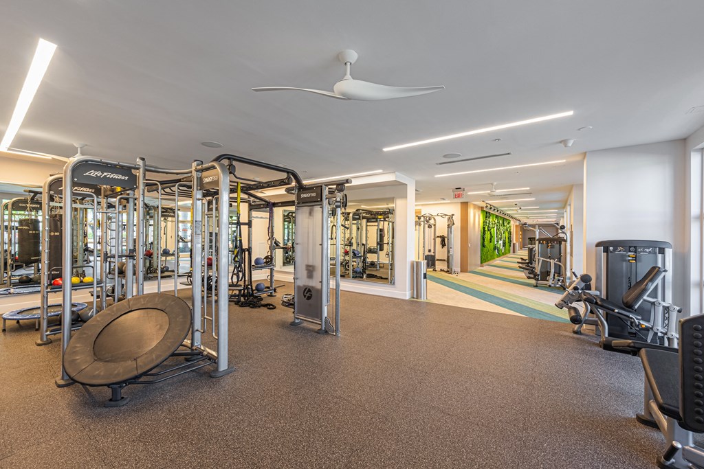 a gym with cardio equipment and weights in a building