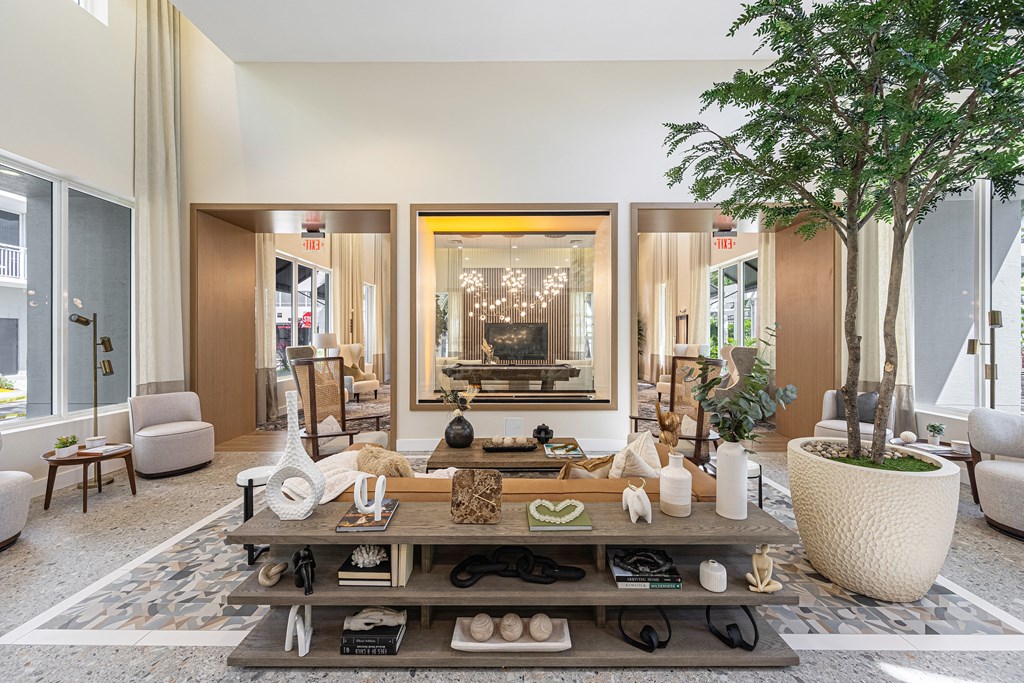 a living room filled with furniture and a tree