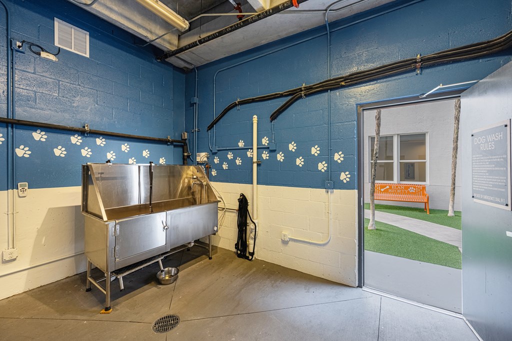 a room with a stainless steel sink and a door