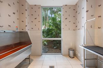 a kitchen with a door to a garden
