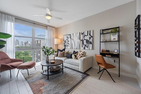 a living room with a large window and a couch