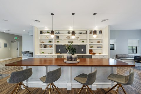 a dining room with a table and chairs in front of a kitchen