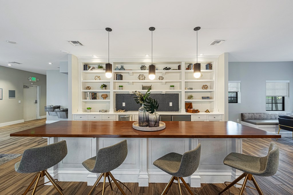 a dining room with a table and chairs in front of a kitchen