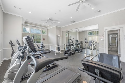 a gym with treadmills and other exercise equipment